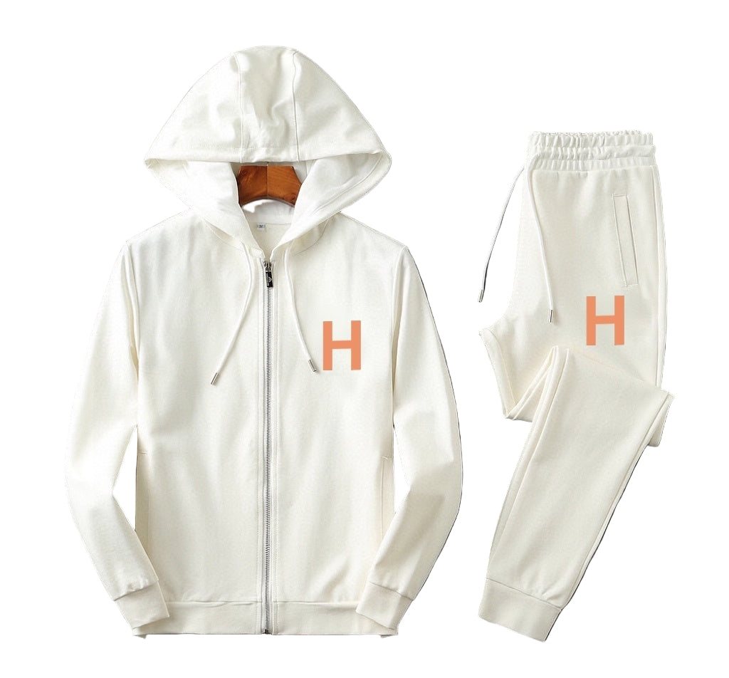 White hoodie and pants set with orange 'H' grapic on a background