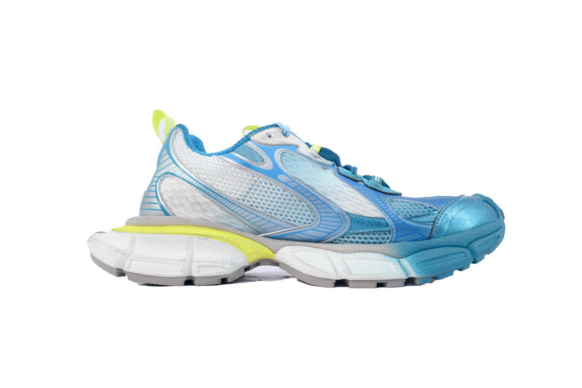 Blue and white athletic shoe with yellow accents on a white background