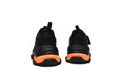 Black and orange sneakers on a white background