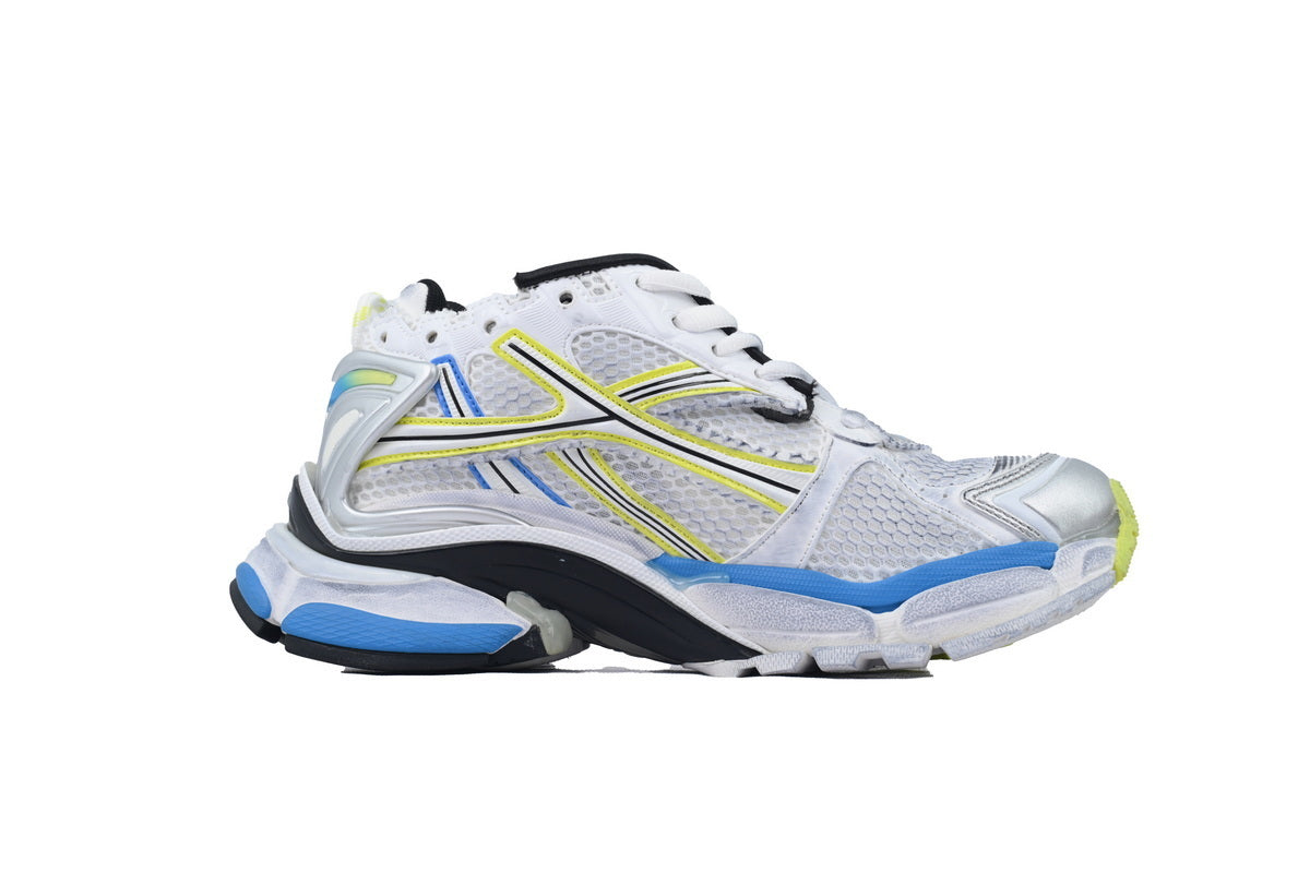 White running shoe with blue and yellow accents on a white background