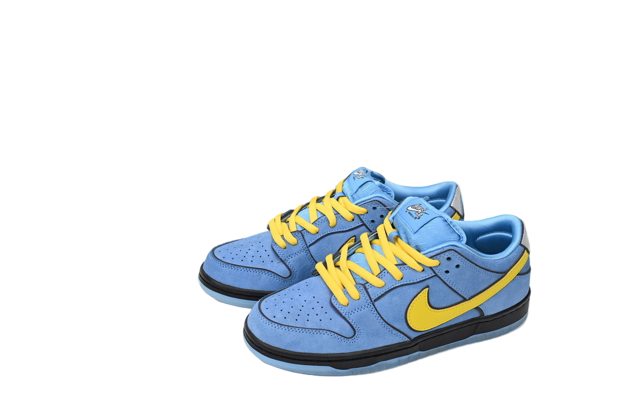 Blue sneakers with yellow accents and a  box in the background