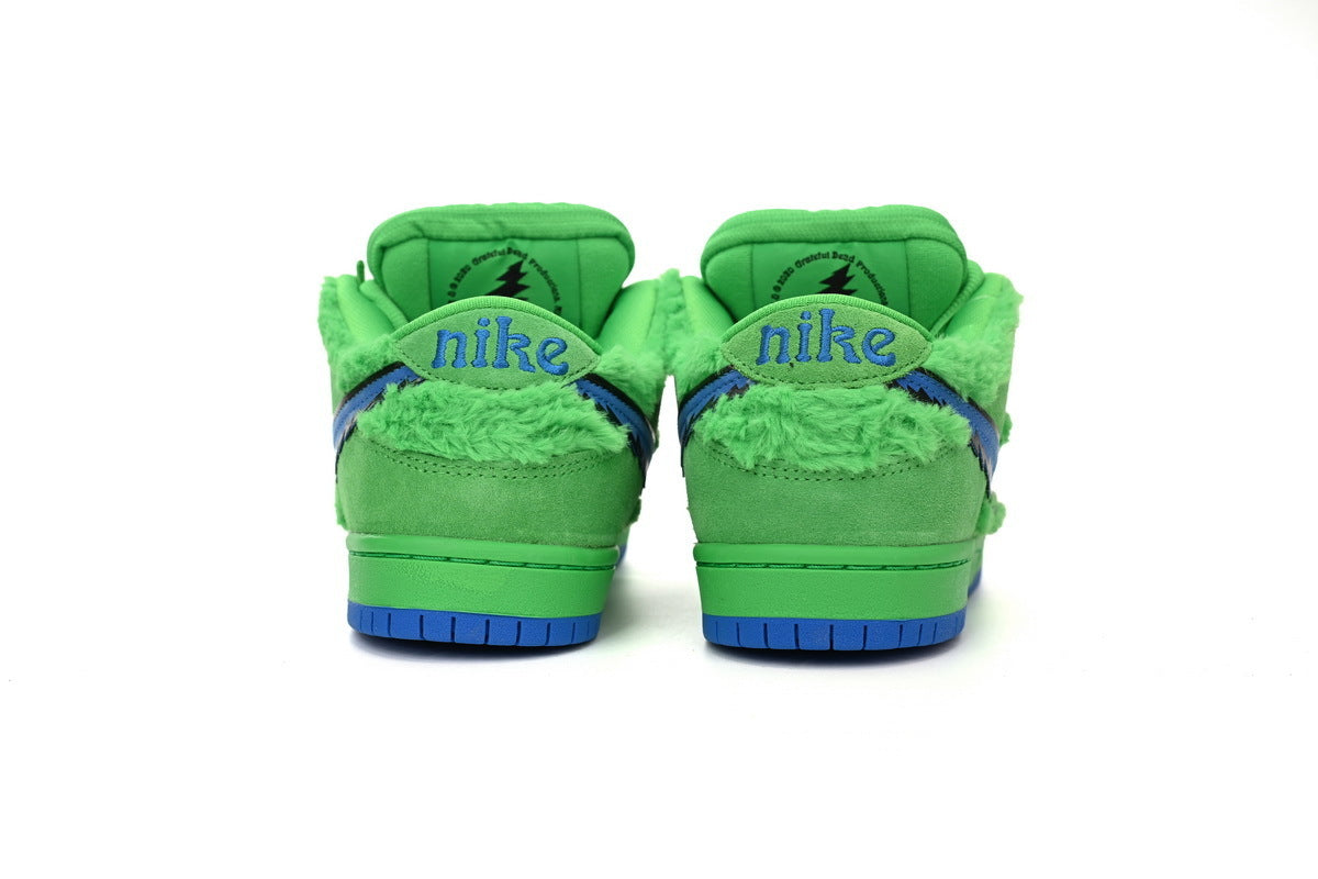 Green sneakers with blue accents on a white background