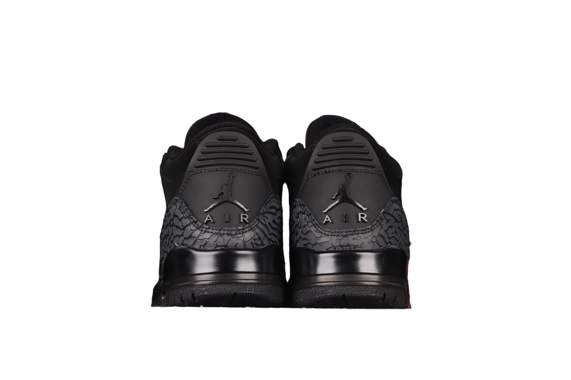 Black sneakers with a black background