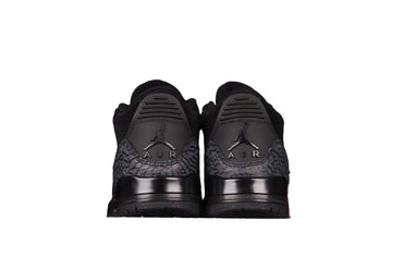 Black sneakers with a black background