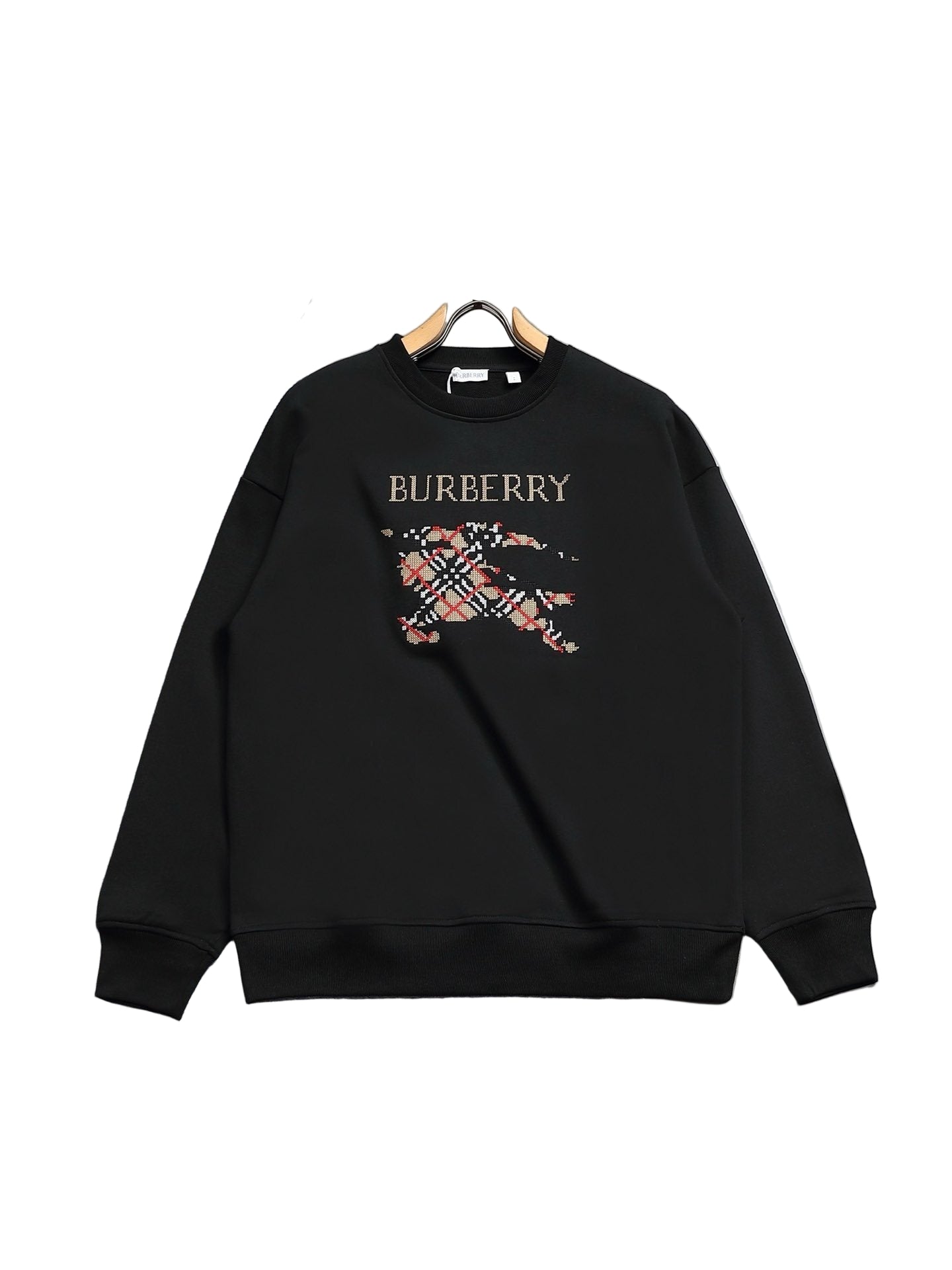 Black  sweatshirt on a hanger against a gray background