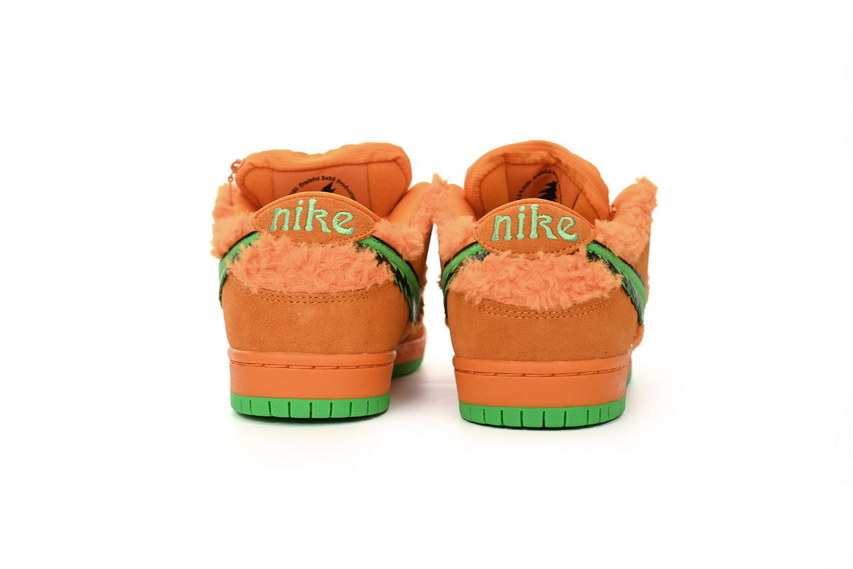 Orange  sneakers with green accents on a white background
