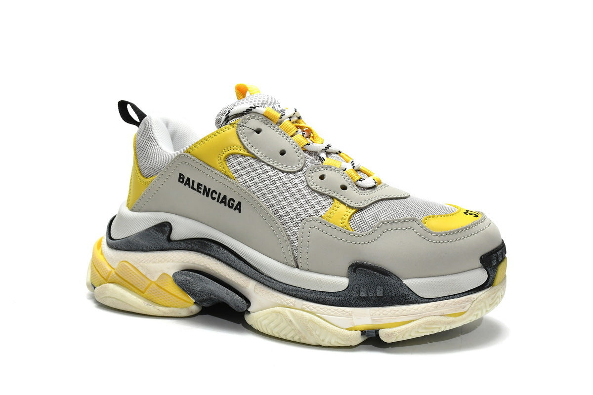 Gray and yellow sneaker on a white background