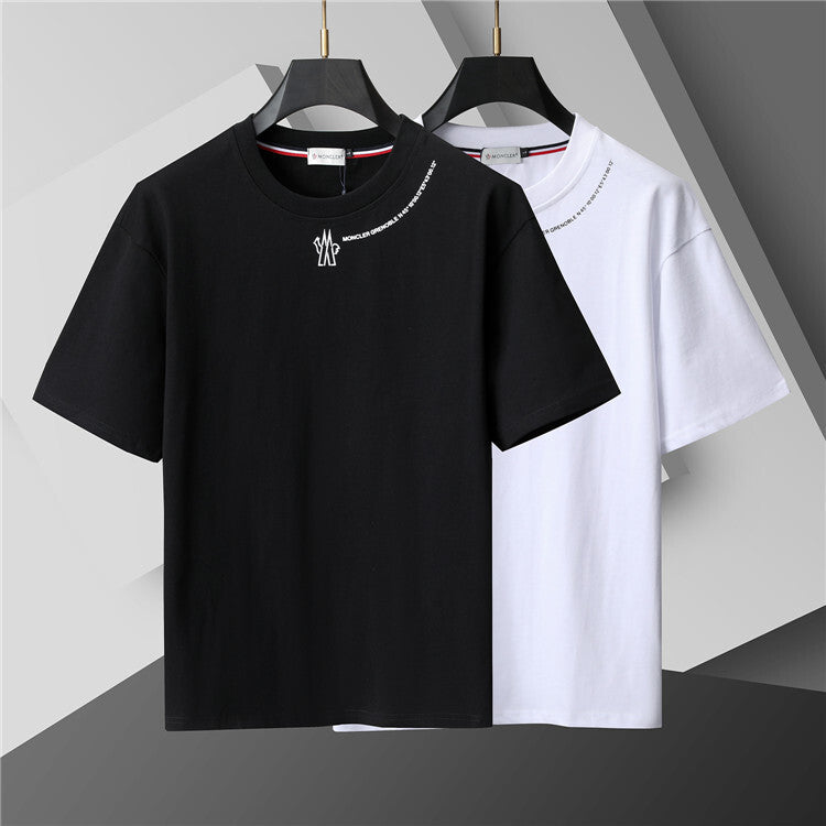 Black and white t-shirts on hangers against a gray background