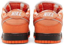 Orange sneakers with white accents on a white background