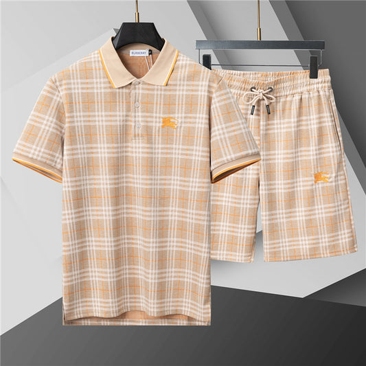Plaid shirt and shorts set on hangers against a gray background
